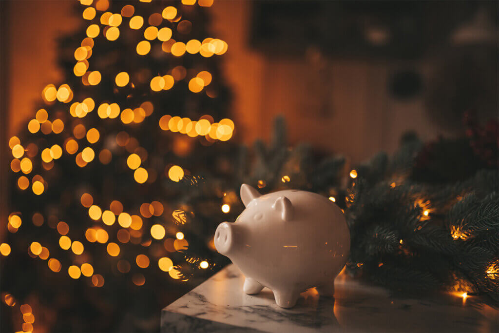 Piggy bank with holiday lights in the background